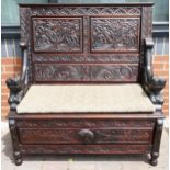 An Ornately Carved Dark Oak Monks Bench/Settle. H: 117cm, W: 110cm