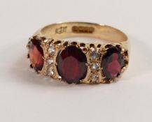 9ct gold ladies ring set with three garnets surrounded by diamonds, size n/o, 4.1g.