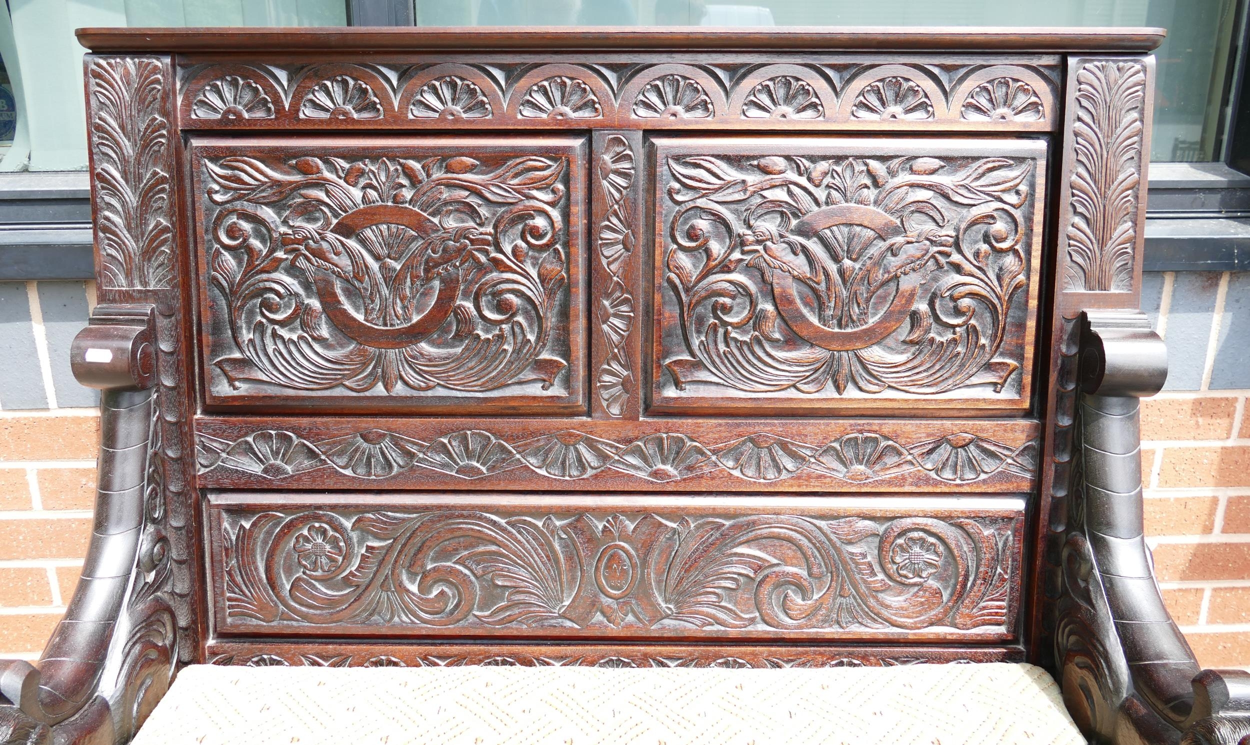 An Ornately Carved Dark Oak Monks Bench/Settle. H: 117cm, W: 110cm - Image 2 of 4