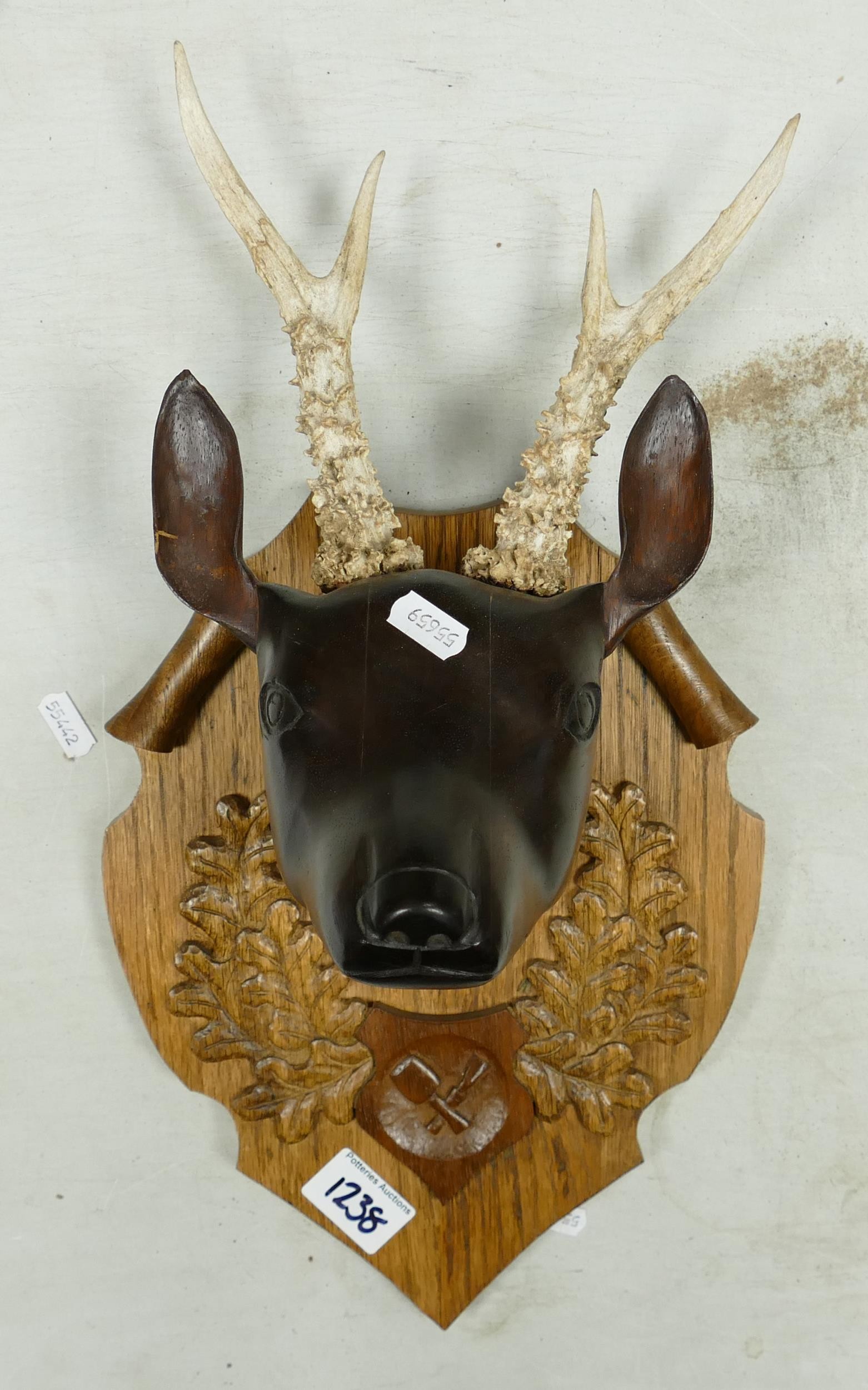 Hand carved wooden plaque of Reindeer with with original antlers