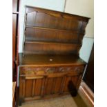 An oak Priory style dresser, 126cm W x 48cm D x 169cm H.