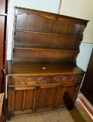 An oak Priory style dresser, 126cm W x 48cm D x 169cm H.