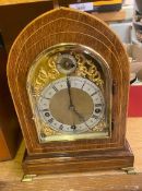 Inlaid Oak Cased Mantle Clock on Brass bracket feet (1 hand is loose and needs re attaching).