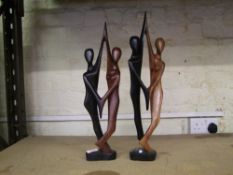 Two large African hardwood hand carved figures of stylised dancing couples: tallest 50cm in height.