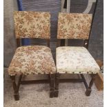 A pair of early/mid 20th century dark oak chairs with non matching upholstery and stretchered turned