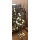 Very large cast metal fireside knight holding a poker in axe form, height 85cm.