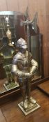 Very large cast metal fireside knight holding a poker in axe form, height 85cm.