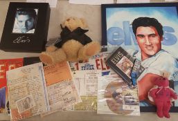 A collection of Elvis memorabilia including Elvis teddy bear, reproduced Elvis documents, fan club