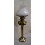 Brass oil lamp with column support, complete with chimney and white glass shade.