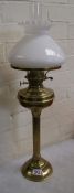 Brass oil lamp with column support, complete with chimney and white glass shade.