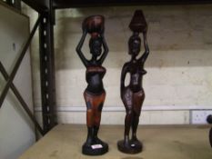Two large African hardwood hand carved figures of tribal ladies carrying food/water: tallest 58cm in