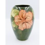 Moorcroft Hibiscus on green ground vase: height 18cm.