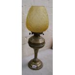 Brass oil lamp with yellow glass shade, no chimney.