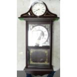 Two modern quartz clock. One wall hanging other with a wooden mantle clock