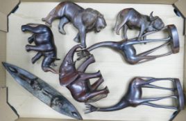 A collection of African carved animal figures including lion, Rhino, Girraffe etc