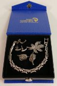 A collection of Silver marquisate style jewellery including tennis bracelet, brooches and two