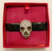 Butler & Wilson costume jewellery watch with silver effect diamante skull case, on faux crocodile