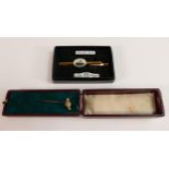 15ct tie pin with yellow metal pin, 1.1g and Rolled gold Lion brand ship tie pin, both boxed. (2)