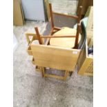 A wooden folding table: pair of dining chairs and a small wooden storage unit.