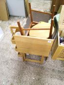 A wooden folding table: pair of dining chairs and a small wooden storage unit.