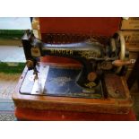 A oak cased Singer hand crank sewing machine, number F8697449.