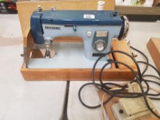 Vintage 'new home' cased electric sewing machine with instructions