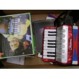 A child's mini accordion with box and instructions together with a selection of music books (1