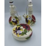 Moorcroft Hibiscus pair of lamp bases together with a lidded pot ( chip to lid inner rim). Height of