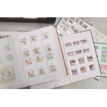 A varied stamp collection of 5 stamp albums each containing stamps pertaining to one of 5