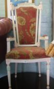 An Asian high-back open armchair with red floral upholstery.