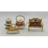 Royal Crown Derby miniature ornaments including garden bench, milk pail, large kettle and iron.