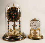 Kundo glass domed mantle clock with instructions and key, together with a smaller Koma domed