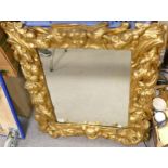 Antique large embossed mirror with images of cupids and foliage. 85cm x 71cm