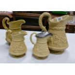 Ridgway Salt Glazed Graduated Set of Three Embossed Water Jugs with similar lidded item, tallest