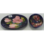 Walter Moorcroft Anemone oval dish and Magnolia round plate, d.25cm. (2)