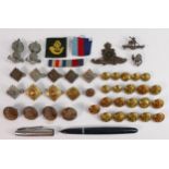A collection of military badges, button and ribbons: including Ubique cap badges, Parker fountain