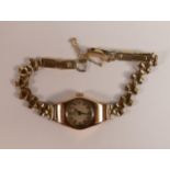 9ct gold hallmarked case record ladies wrist watch, winds and ticks. Bracelet rolled gold.