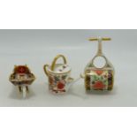 Royal Crown Derby miniature ornaments including wheelbarrow, garden roller and watering can. Tallest