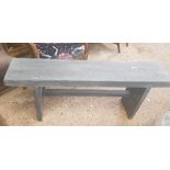 Grey painted bench made from scaffold planks.