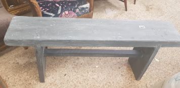 Grey painted bench made from scaffold planks.