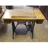 Singer sewing machine treadle table with sewing machine, 77cm H x 92cm W x 44cm D.