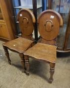 Pair of early 20th century mahogany shield-back hall chairs.