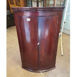 Mahogany wall hanging corner cabinet.