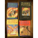 A group of 4 Harry Potter first edition hardback books including a Deluxe edition of Harry Potter