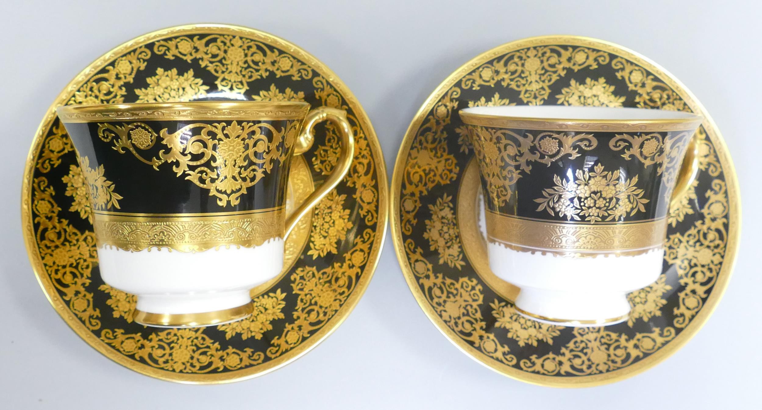 De Lamerie Fine Bone China heavily gilded Black Exotic Garden patterned cup & saucer sets, specially