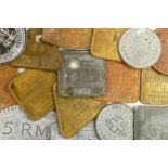 A collection of vintage metal war tokens, including German occupation tags Jersey, Organisation