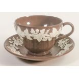 A Wedgwood Norman Wilson tea cup & saucer. Produced in a chocolate brown Aventurine glaze with