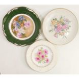 Three hand decorated wall plates with images of flowers, two signed J L Evans, each with diameter of