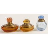 Heavy coloured glass inkwells with brass mounts, tallest 12.5cm. (3)
