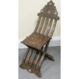 A middle Eastern hardwood folding chair, the ogee shaped back with mother of pearl inlay, and turned